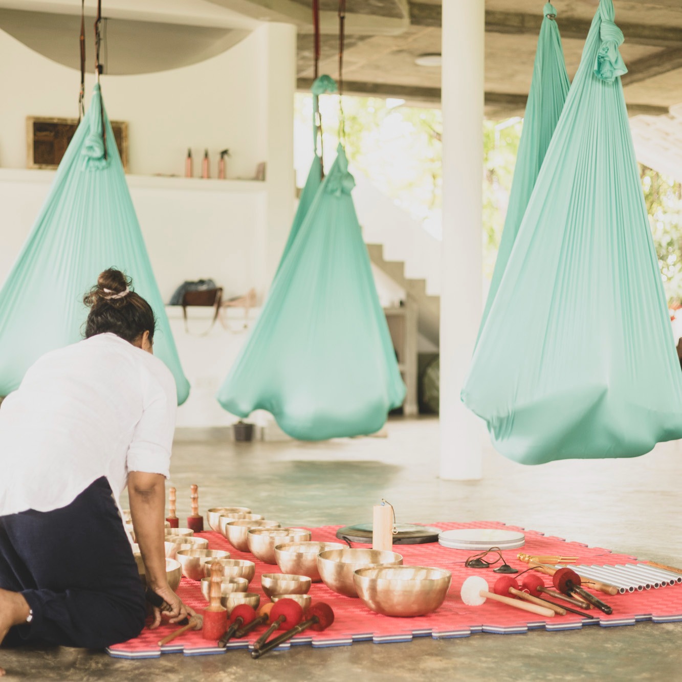 Silks hanging from the shala beams in the morning light